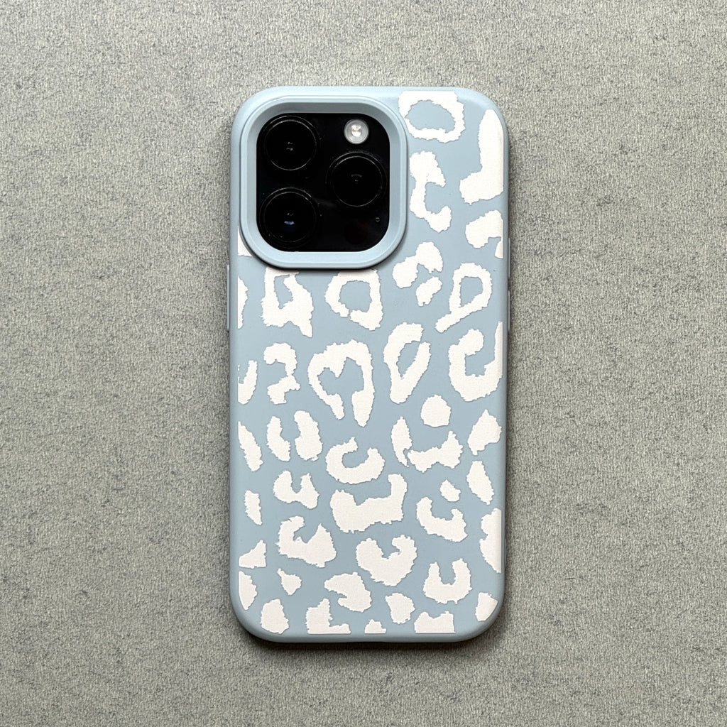 Phone case with white leopard print on a light blue background