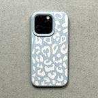 Phone case with white leopard print on a light blue background