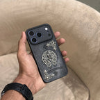 Person holding a phone with a decorative case 